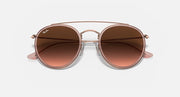 Round metal sunglasses with rose-gold frame and brown mirrored lenses, straight-on view