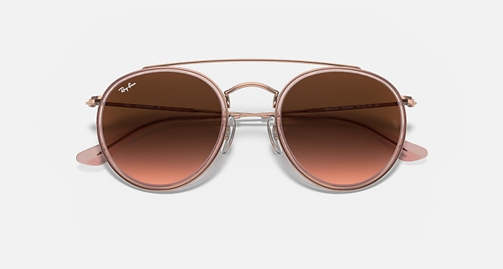 Round metal sunglasses with rose-gold frame and brown mirrored lenses, straight-on view