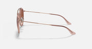 Rose-gold metal sunglasses with round brown lenses, side profile and temple arms