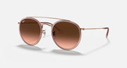 Round metal sunglasses with rose-gold frame and brown mirrored lenses, side profile