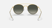 Ray-Ban round sunglasses with gold frame and dark gradient lenses, straight-on front view