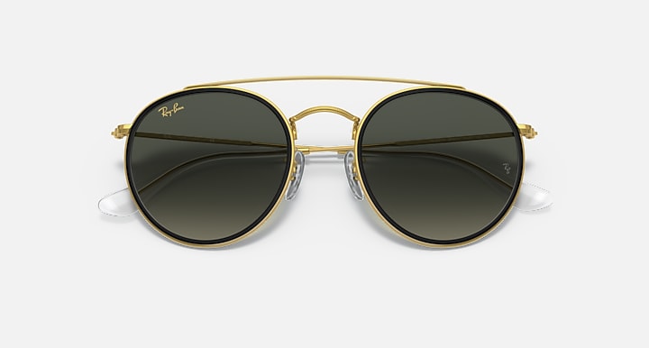 Ray-Ban round sunglasses with gold frame and black-tinted gradient lenses