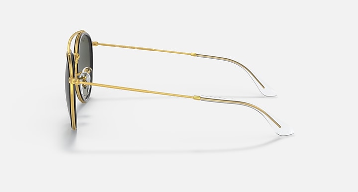 Ray-Ban round sunglasses, gold frame side view with curved temple and dark lenses