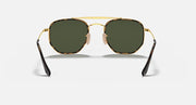 Gold hexagonal sunglasses with dark green lenses and black-tinted temple tips