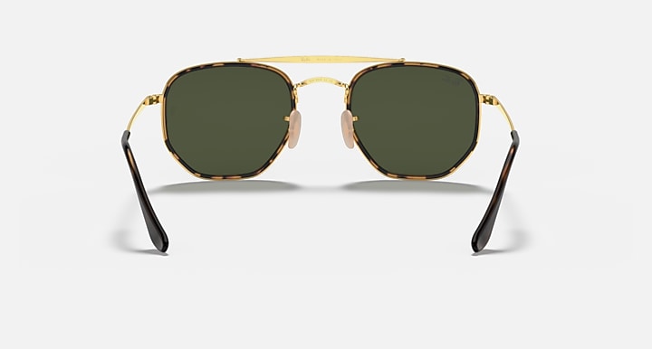 Gold hexagonal sunglasses with dark green lenses and black-tinted temple tips