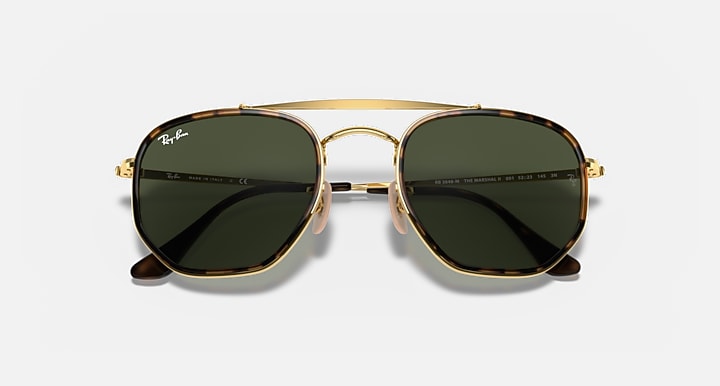 Gold hexagonal sunglasses with dark green lenses, front view with hinge hardware