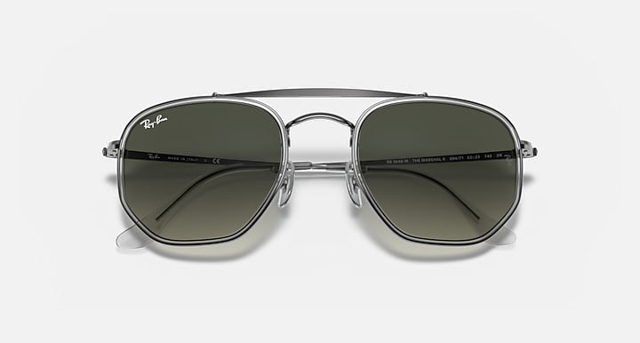 Gunmetal hexagonal sunglasses with dark gray-green lenses and central bridge detail