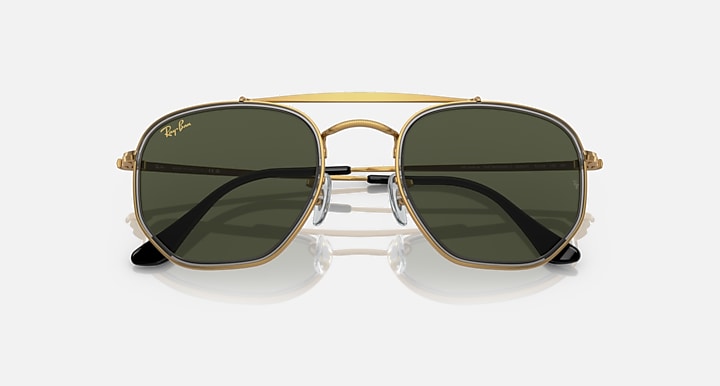 Hexagonal sunglasses front view with gold frame and dark green mirrored lenses