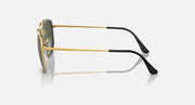 Hexagonal sunglasses side view, gold frame with dark green lens, black temple tips