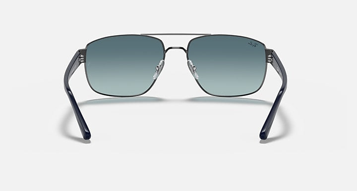 Front view sunglasses with gunmetal frame and blue gradient lenses, curved brow bar