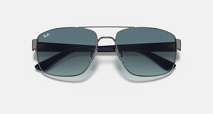 Sunglasses with dark gradient lenses and gunmetal frame, rounded rectangular shape