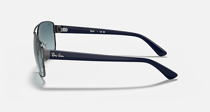 Side-profile sunglasses with blue-gradient lenses and dark gunmetal metal temples