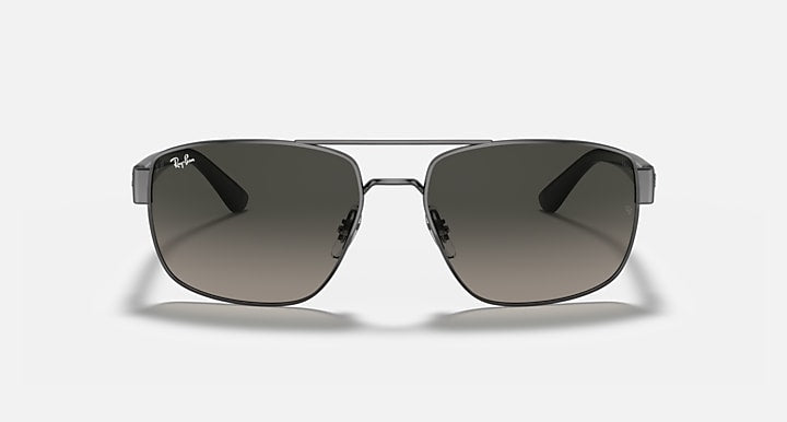 Sunglasses with brown-to-dark gradient lenses and gunmetal frame, rounded rectangular shape