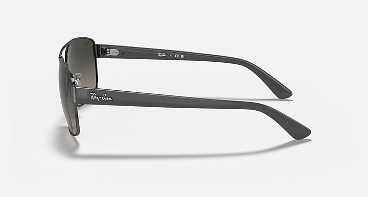 Side-profile sunglasses with dark gradient lenses and gunmetal metal temples
