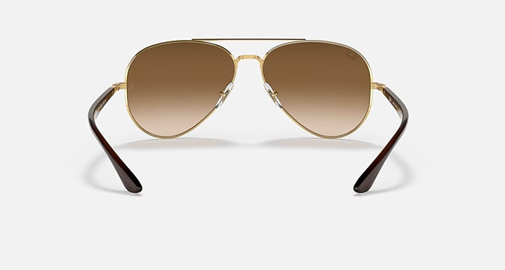 Ray-Ban aviator sunglasses with gold frame and warm brown lenses, front view