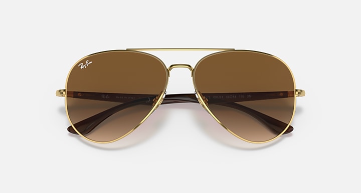 Ray-Ban aviator sunglasses with gold frame and dark brown lenses, front view