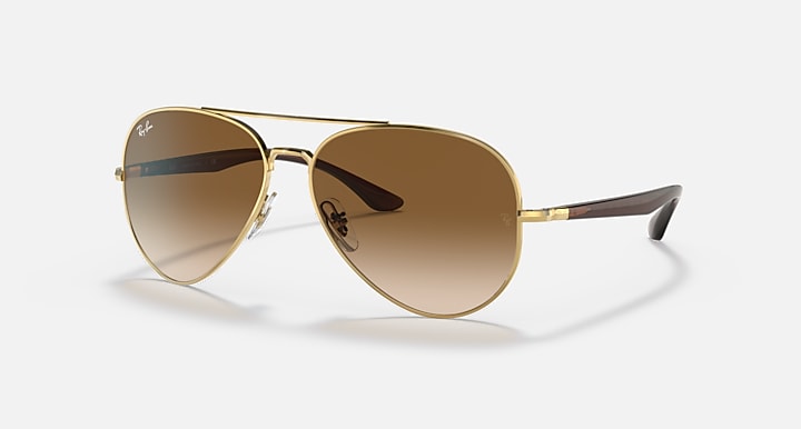 Ray-Ban aviator sunglasses with gold frame and blue-to-brown gradient lenses