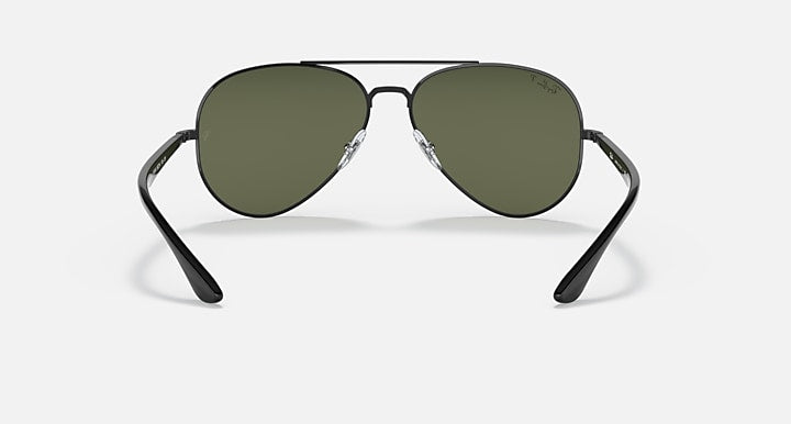 Ray-Ban aviator sunglasses with dark green lenses and dark metal frame, front view with temples visible.