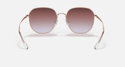 Rose gold round sunglasses with brown gradient lenses, front view with visible hinges