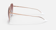 Rose gold metal sunglasses with brown gradient lenses, side profile with temple arms