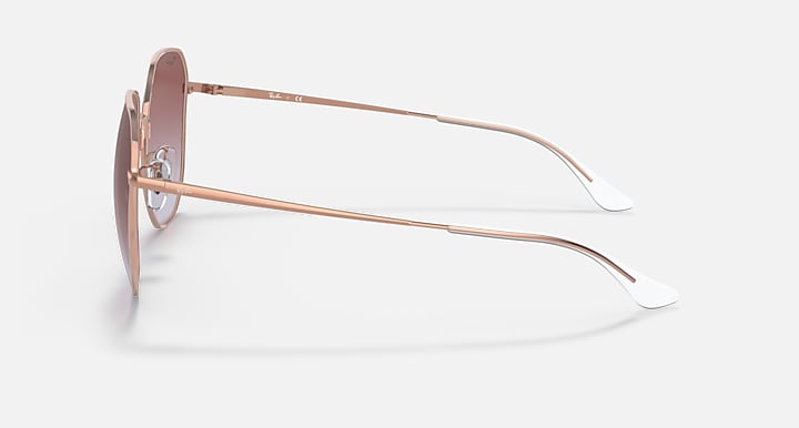Rose gold metal sunglasses with brown gradient lenses, side profile with temple arms