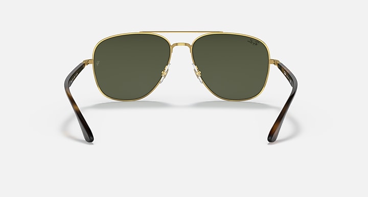 Ray-Ban aviator sunglasses front view, gold frame with dark green lenses and dark arms