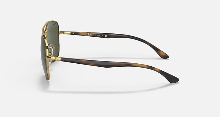 Ray-Ban aviator sunglasses side view, gold frame with dark green lenses and dark temples