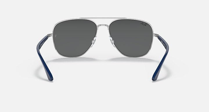 Silver-tone aviator sunglasses with dark gray lenses and blue arms.