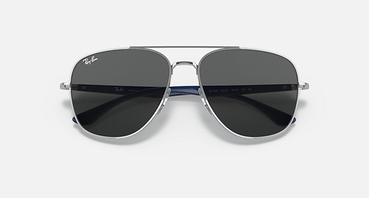 Silver-tone aviator sunglasses with dark lenses and thin blue accents.