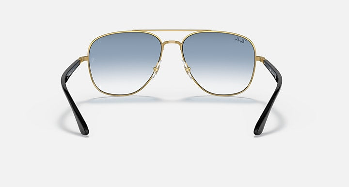 Gold-tone aviator sunglasses with light blue gradient lenses and black arms.