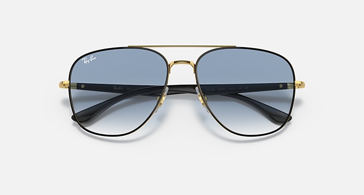 Gold-tone aviator sunglasses with dark lenses and black temple tips.