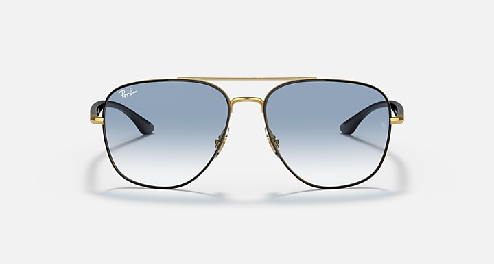 Gold-tone aviator sunglasses with light blue gradient lenses and dark blue arms.