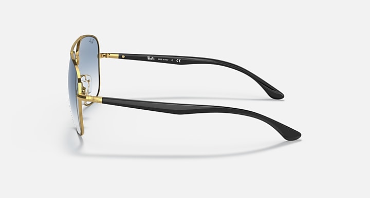 Gold-tone aviator sunglasses with black temples and dark lenses.