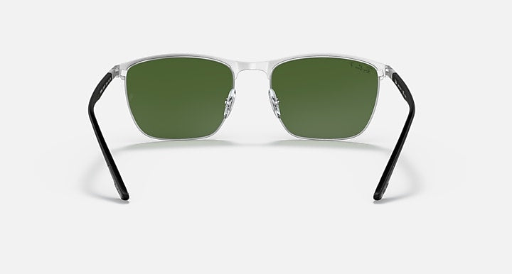 Sunglasses with green lenses and clear light frame, front view
