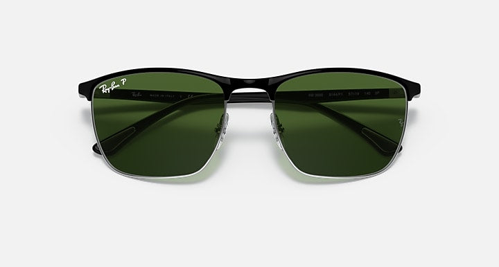 Sunglasses with green mirrored lenses and black frame, top-front view