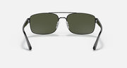 Sunglasses with silver-toned frame and green gradient lenses, front view.