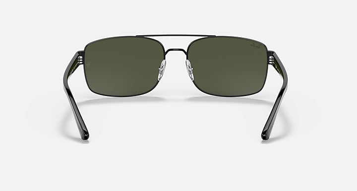 Sunglasses with silver-toned frame and green gradient lenses, front view.