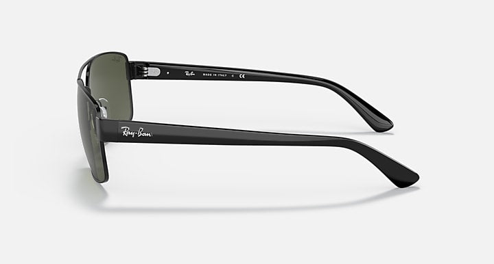 Side view of black sunglasses with green gradient lenses and slim temples.