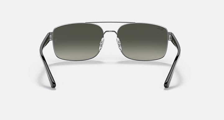 Silver-toned sunglasses with green gradient lenses, front view on a simple background.