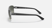 Side view of silver-toned sunglasses with green gradient lenses and slim temples.