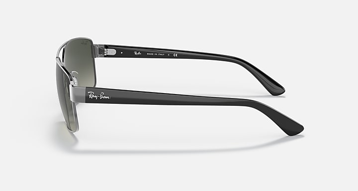 Side view of silver-toned sunglasses with green gradient lenses and slim temples.