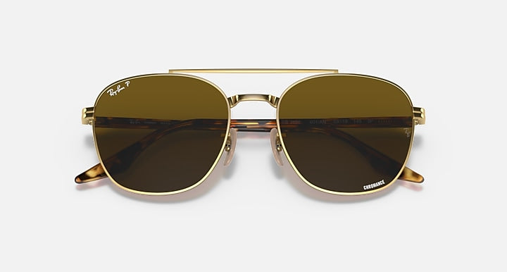 Ray-Ban sunglasses with gold-tone frame and dark brown lenses, front close-up