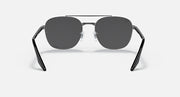 Round sunglasses with dark gray lenses and black metal frame, symmetrical front