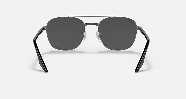 Round sunglasses with dark gray lenses and black metal frame, symmetrical front