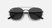 Round sunglasses with dark gray lenses and black metal frame, front close-up