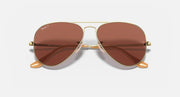 Gold aviator sunglasses with brown lenses and dual-tone temple arms