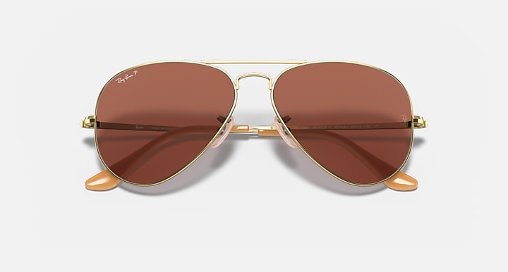 Gold aviator sunglasses with brown lenses and dual-tone temple arms