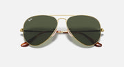 Gold aviator sunglasses with dark green lenses and matching nose bridge