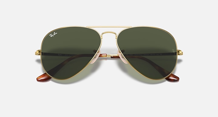 Gold aviator sunglasses with dark green lenses and matching nose bridge