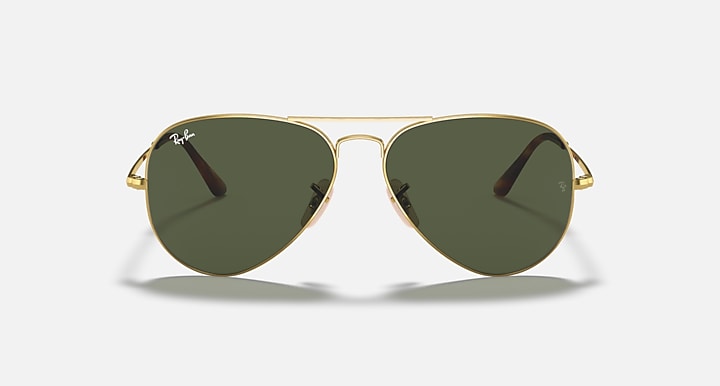 Gold aviator sunglasses with dark green tinted lenses and teardrop frame shape